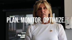 A woman standing in front of a camera with the words " n. Monitor."